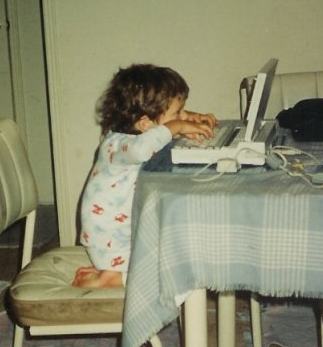 Picture of myself what I was a little kid typing on an old laptop.